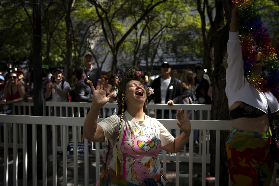 caption: Karin Fellows of Omaha, Nebraska, dances as the Seattle Pride Parade passes by on Sunday, June 25, 2023, at Westlake Park in Seattle.