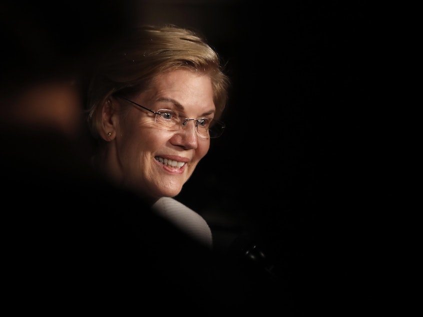 caption: Democratic presidential candidate Sen. Elizabeth Warren, D-Mass., speaks to reporters while attending the Rockingham County Democrats Clambake in Portsmouth, N.H. on Saturday.