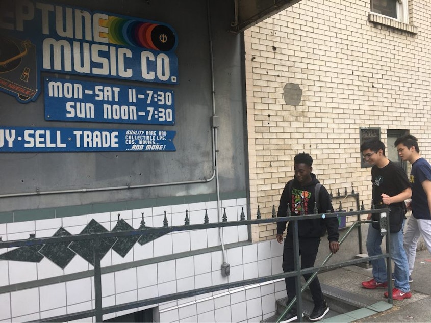 caption: RadioActive's Tre'vion Sinclair, Kenny Ou and Joshua Fernandes go to meet Dave Sandlund at Neptune Music in the University District.