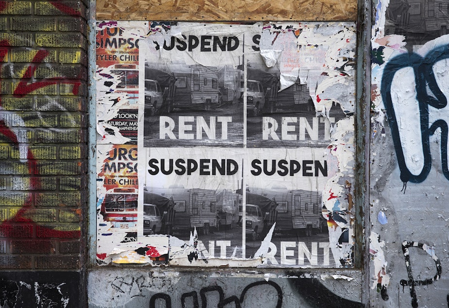 caption: Suspend Rent flyers are displayed on Monday, May 4, 2020, along Second Avenue Extension at the intersection of South Main Street in Seattle.