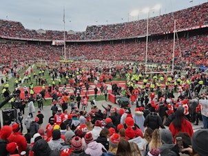 caption: Fans rush the field after the Ohio State Buckeyes defeat the Penn State Nittany Lions 28-17 in November in Columbus, Ohio. The Big Ten and PAC-12 have put fall sports on hold due to the pandemic.