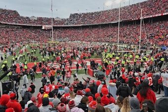 caption: Fans rush the field after the Ohio State Buckeyes defeat the Penn State Nittany Lions 28-17 in November in Columbus, Ohio. The Big Ten and PAC-12 have put fall sports on hold due to the pandemic.