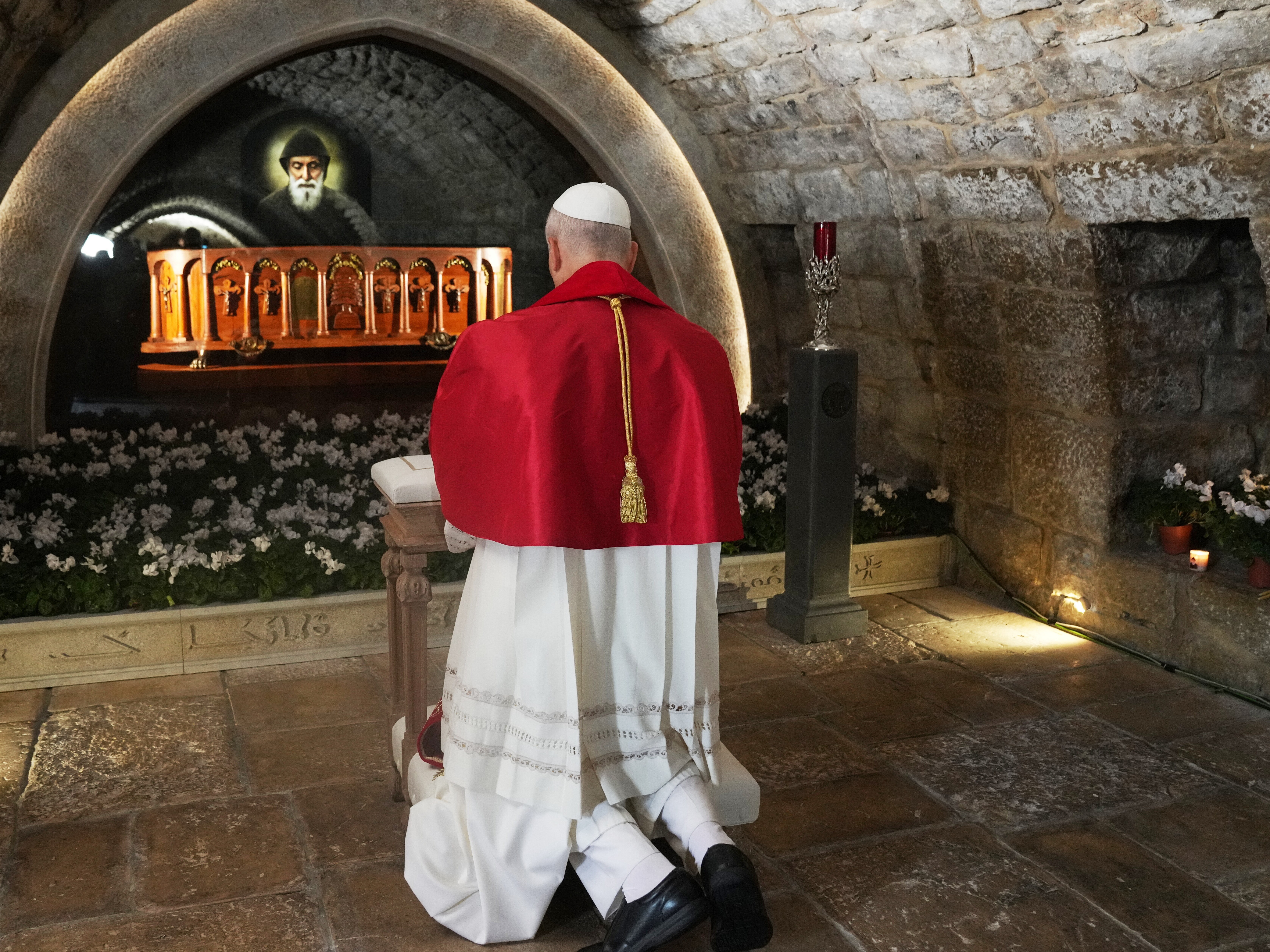caption: Pope Leo XIV prays in front of the tomb of Saint Charbel Makhlouf at the Monastery of Saint Maroun, in Annaya, Lebanon, Monday, Dec. 1, 2025.