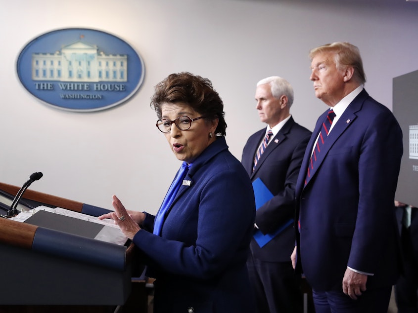caption: Jovita Carranza, administrator of the Small Business Administration, speaks in the James Brady Press Briefing Room of the White House, as Vice President Mike Pence and President Donald Trump listen on April 2, 2020.