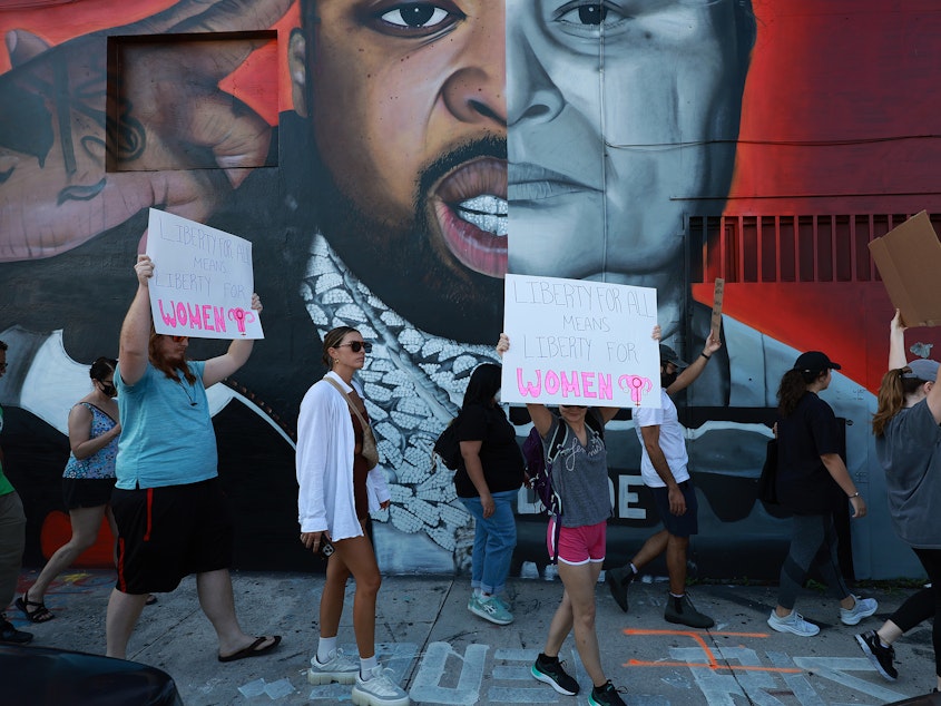 caption: People march to protest the Supreme Court's decision in the <em>Dobbs v Jackson Women's Health</em> case on June 24 in Miami.