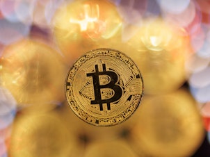 caption: Bitcoin hit a record high following a rally sparked by the Securities and Exchange Commission's approval of bitcoin exchange-traded funds.