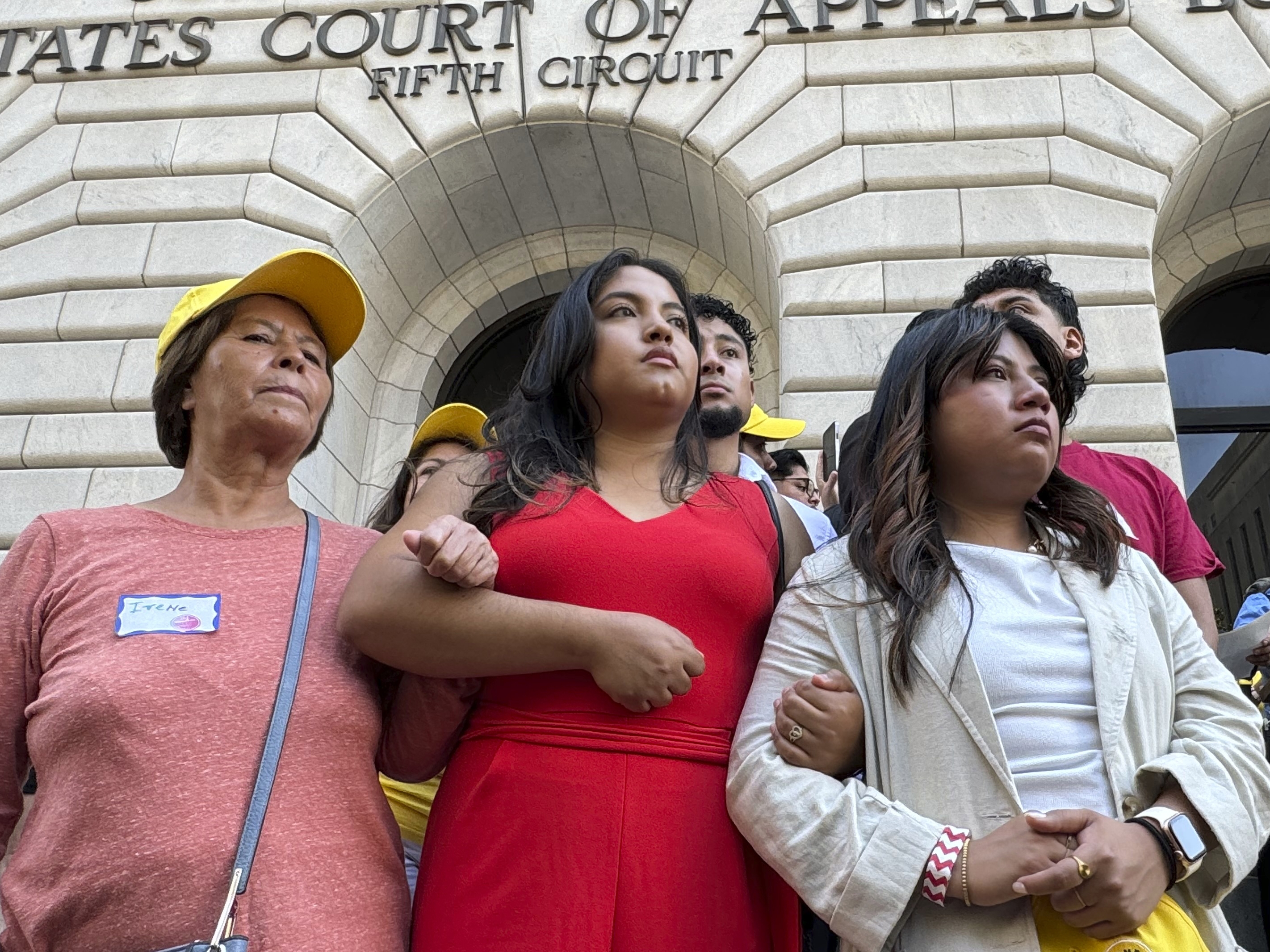 caption: Supporters rally outside the 5th Circuit Court of Appeals in New Orleans on Thursday, Oct. 10, 2024, following a hearing on the future of the Deferred Action for Childhood Arrivals program. A separate lawsuit, filed in a federal district court in North Dakota, challenges a rule allowing DACA recipients to enroll in Affordable Care Act plans this year.