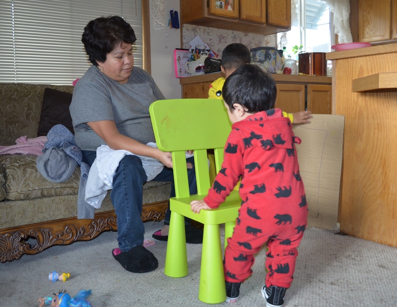 caption: Araceli Martinez cares for children in her home daycare near Tacoma. She says she learned a lot about how to reduce asthma risk for kids in her home.
