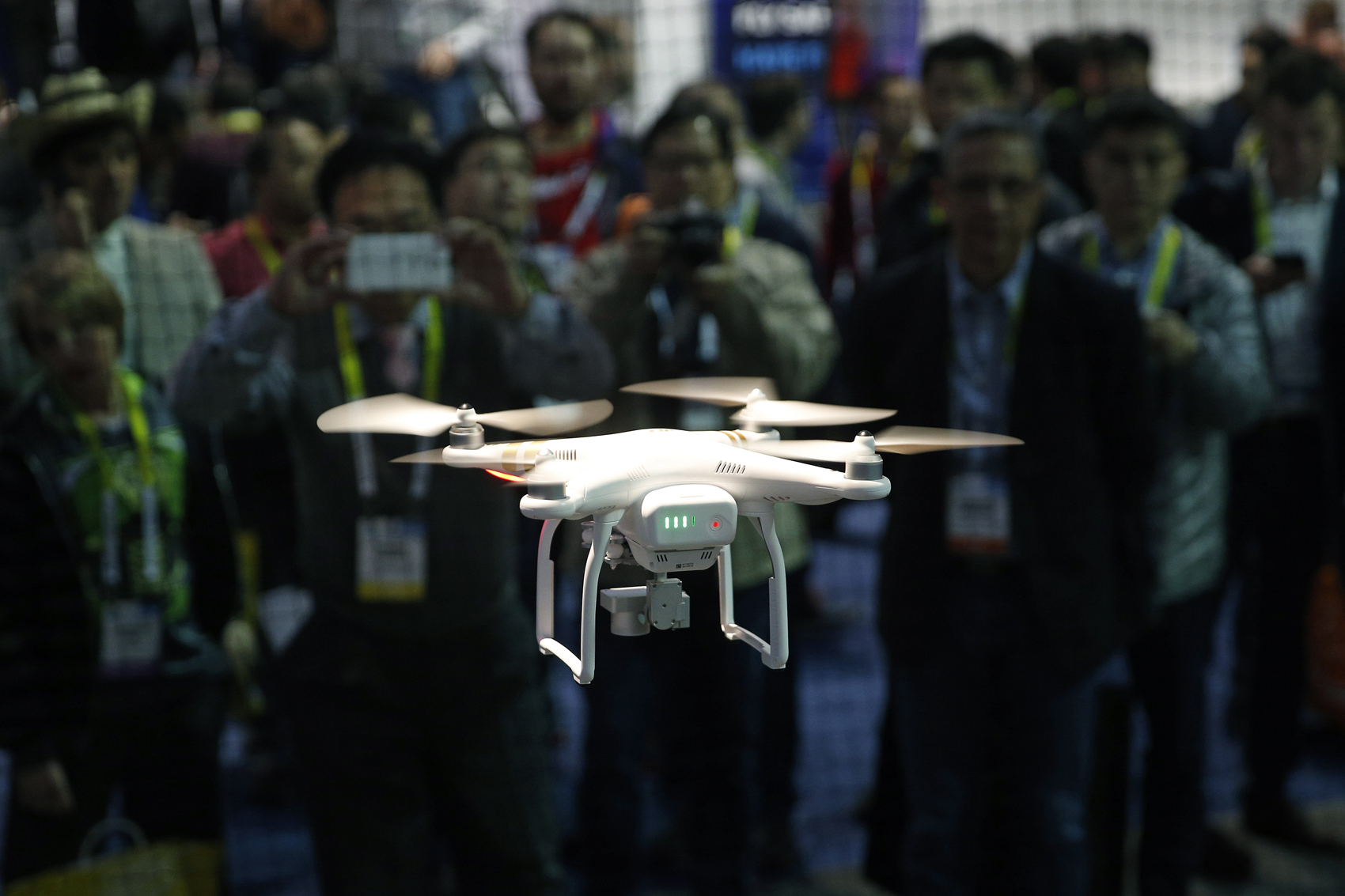 caption: A drone hovers at the DJI booth during CES International in Las Vegas. (John Locher, File/AP)