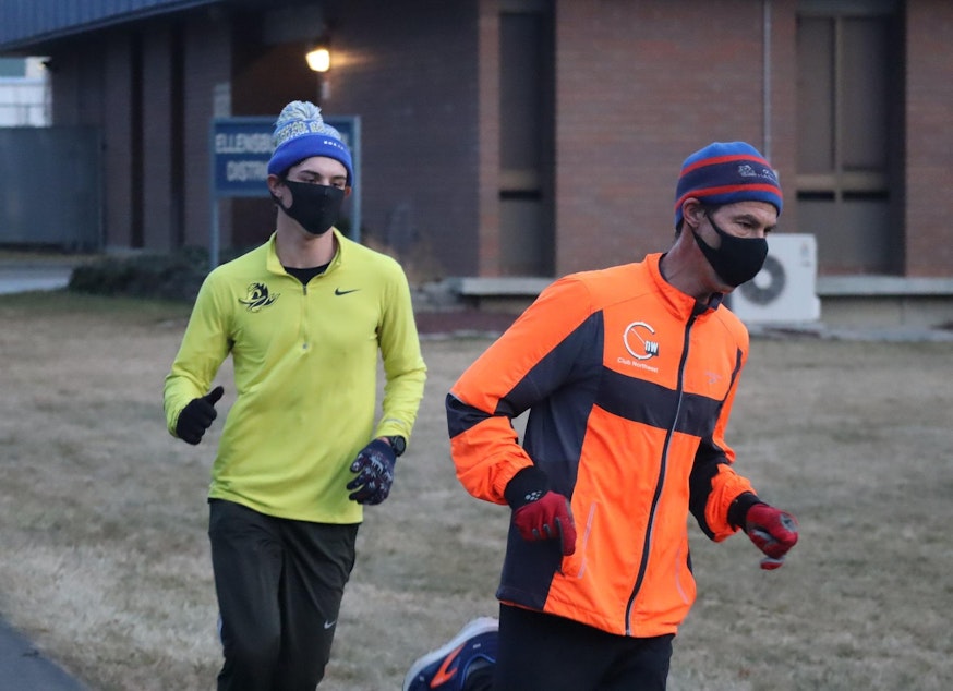 caption: Coach Jeff Hashimoto, right, and high school senior Bryton Wilson finish a masked training run in Ellensburg on Monday.