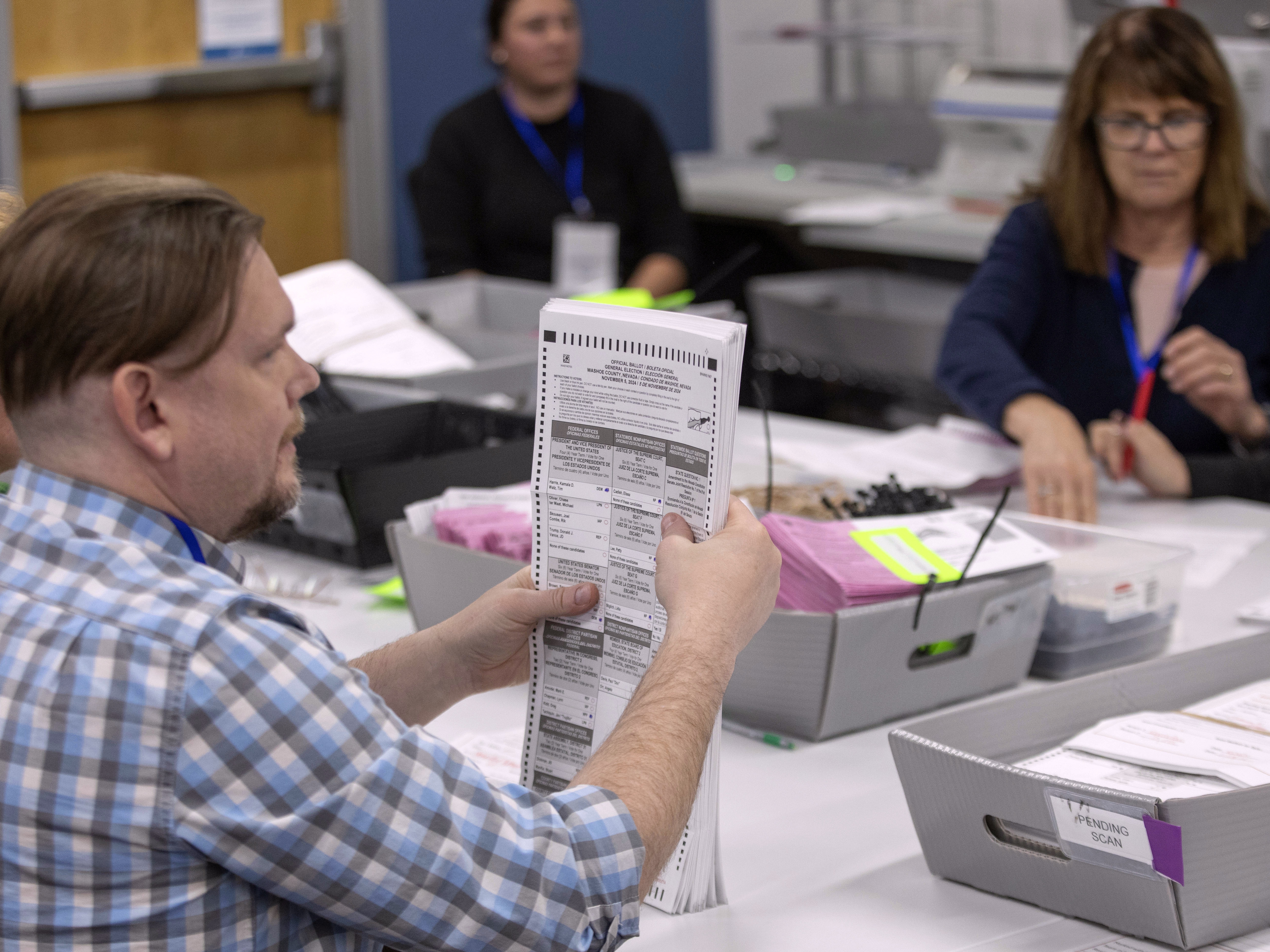 caption: Election workers sort ballots last week at the Registrar of Voters Office in Reno, in Nevada's Washoe County.
