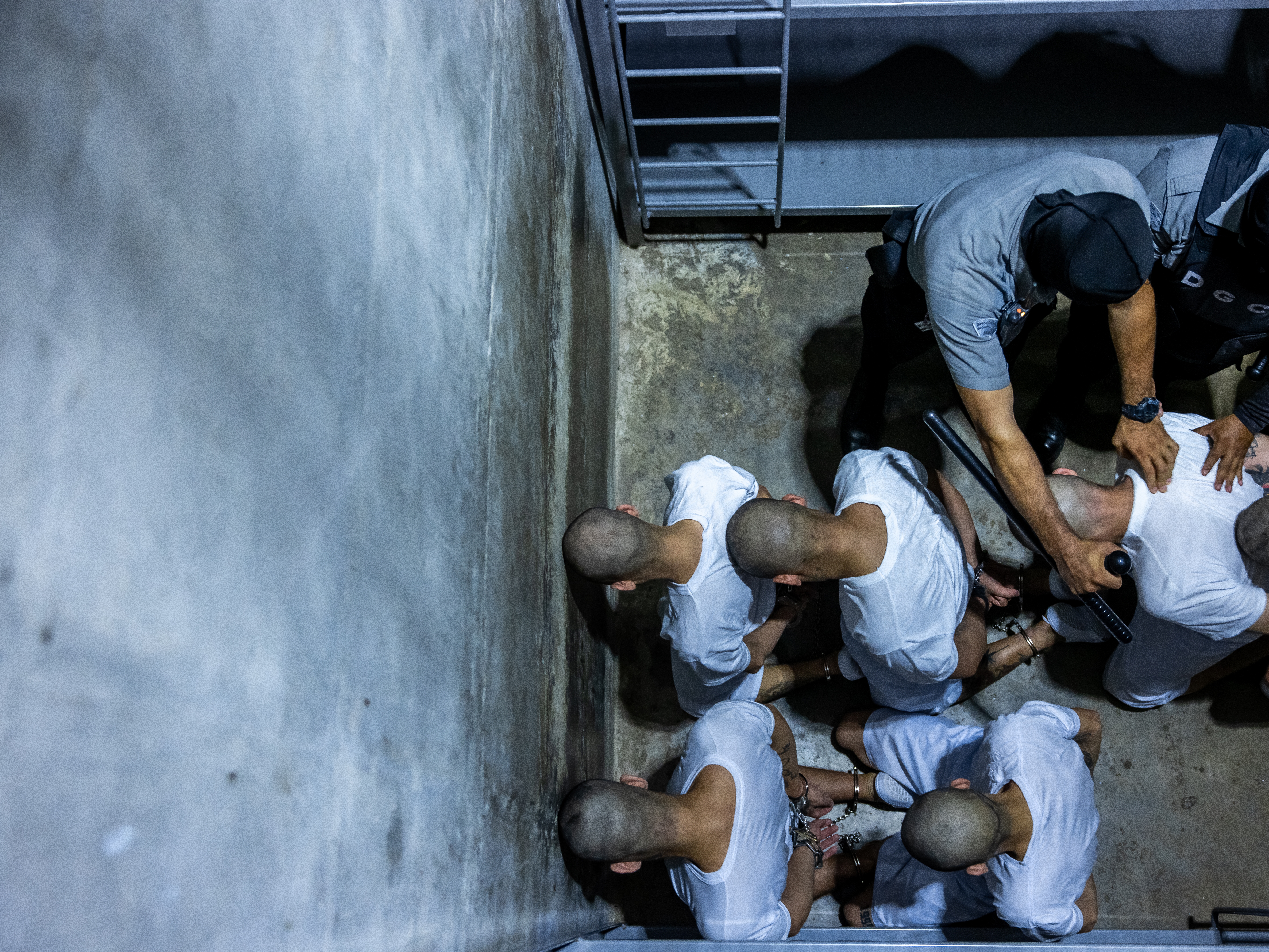 caption: 17 members of Venezuela's Tren de Aragua gang and members of the MS-13 gang, who were deported to El Salvador by the US in San Salvador, El Salvador on March 31, 2025. El Salvador's President Nayib Bukele confirmed they will be sent to the country's infamous mega-prison at CECOP facility prison. San Salvador forces took heavy security measures.