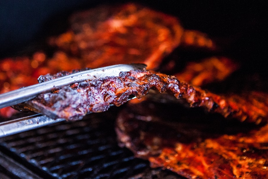 caption: Ribs cook on the barbecue pit and Real BBQ and More in Shreveport, La.