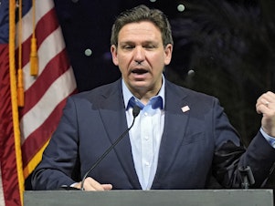 caption: Florida Gov. Ron DeSantis speaks at a Feb. 8 luncheon in Tampa, Fla. Climate change will be a lesser priority in Florida and largely disappear from state statutes under legislation signed Wednesday by DeSantis.
