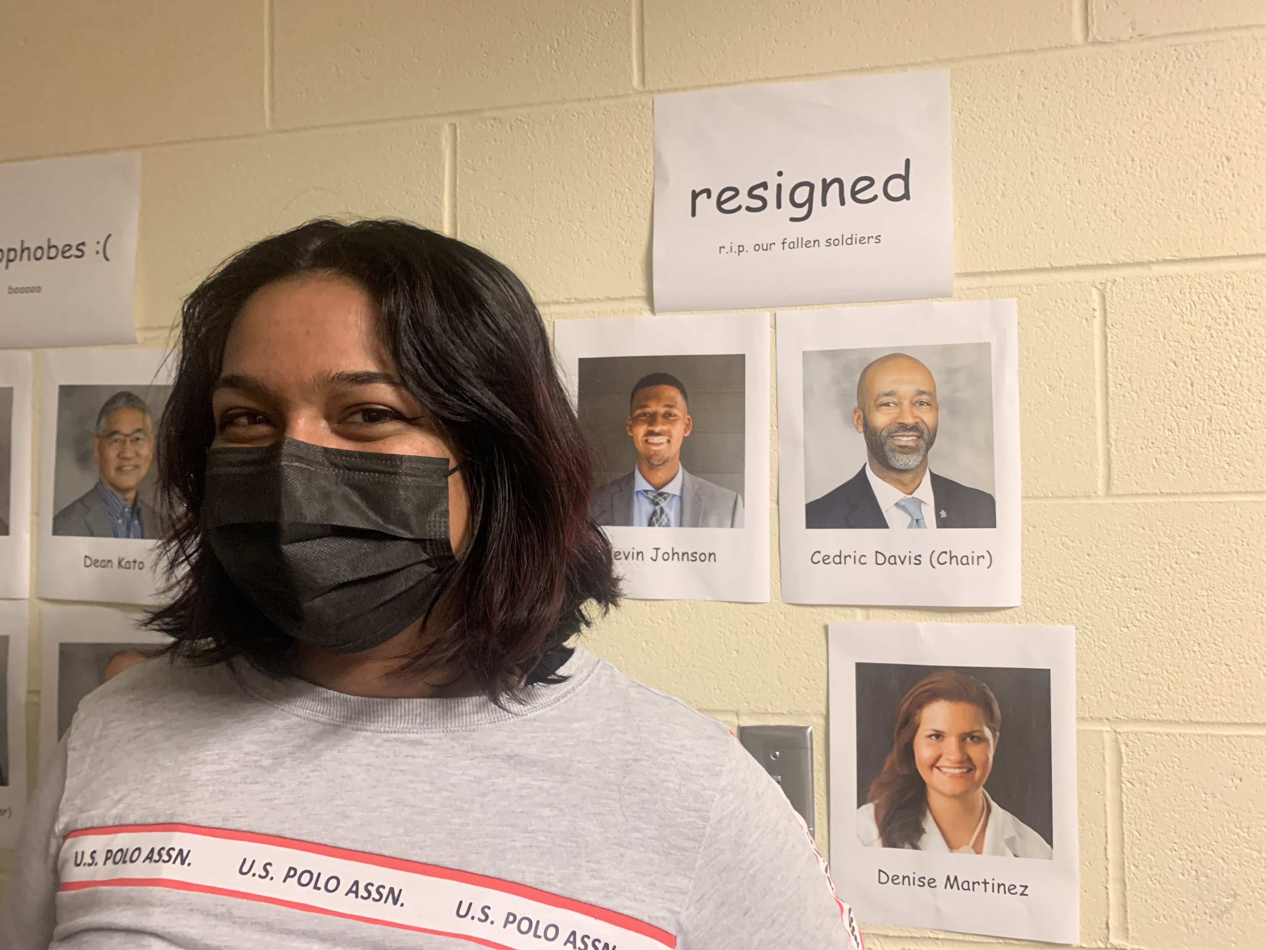 caption: SPU nursing student Reena Sidhu stands next to a chart categorizing each member of SPU's board of trustees based on their position on the employee lifestyle expectation policy. Sidhu says the employee lifestyle policy has impacted the nursing program's ability to recruit and retain instructors, which then impacts students. 
"I understand it's a theological issue, but [the board of trustees] is not letting the university be a place of education, and that's not acceptable," Sidhu said.