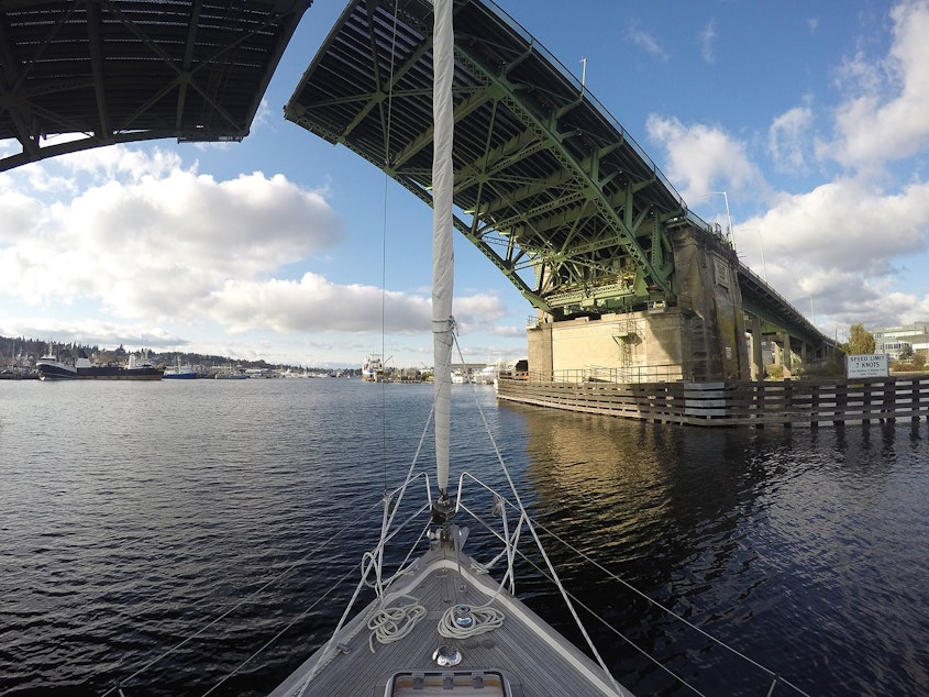 caption: A 36-foot Hallberg-Rassy sailboat travels underneath the Ballard Bridge on Wednesday, November 7, 2018, in Seattle.
