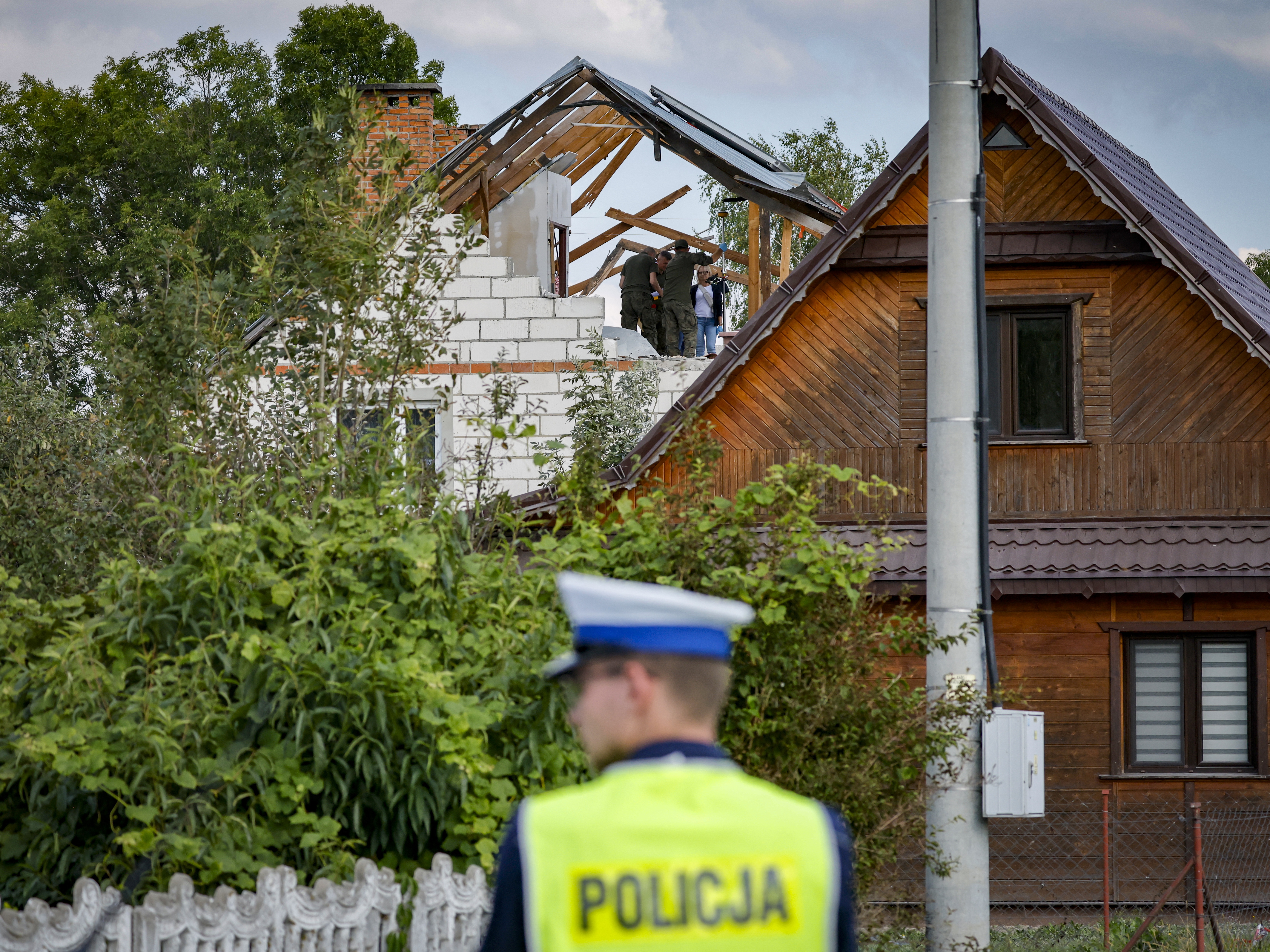 caption: Polish police and military on Wednesday inspect damage to a house from the debris of a drone that was shot down in the village of Wyryki-Wola, eastern Poland. Poland says it shot down several Russian attack drones that violated Polish airspace in overnight Russian attacks on neighboring Ukraine.