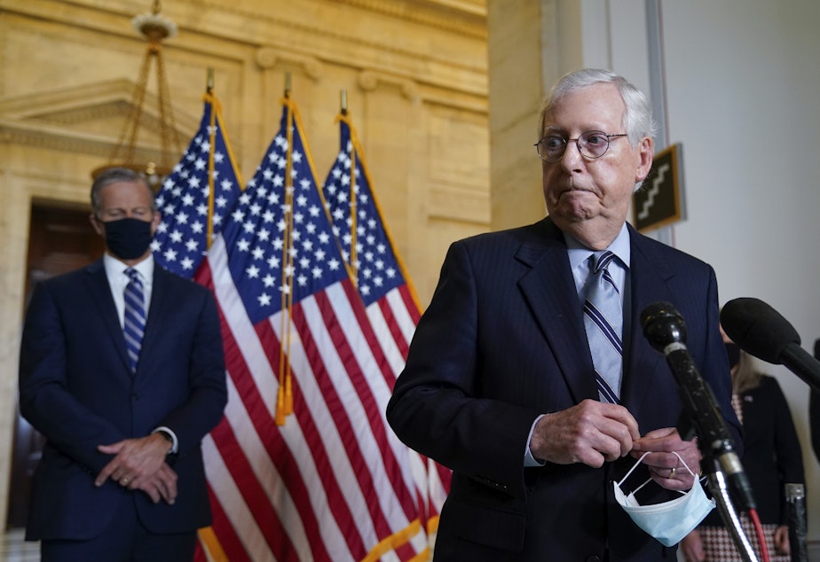 caption: Senate Minority Leader Mitch McConnell, R-Ky., joined by Senate Minority Whip John Thune, R-S.D., left, has argued that President Biden is not governing like the moderate he campaigned as in 2020.