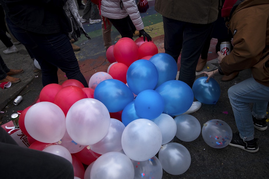 caption: Red, white and blue balloons are shown during an impromptu celebration after Joe Biden was officially named the president elect on Saturday, November 7, 2020, at the intersection of 10th Avenue and East Pine Street in Seattle.