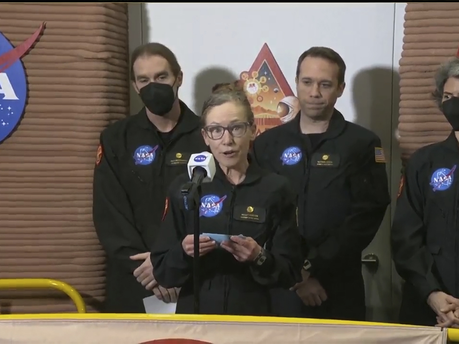 caption: In this image made from video provided by NASA, CHAPEA commander Kelly Haston speaks in front of other crew members at Johnson Space Center in Houston, Texas, on Saturday.