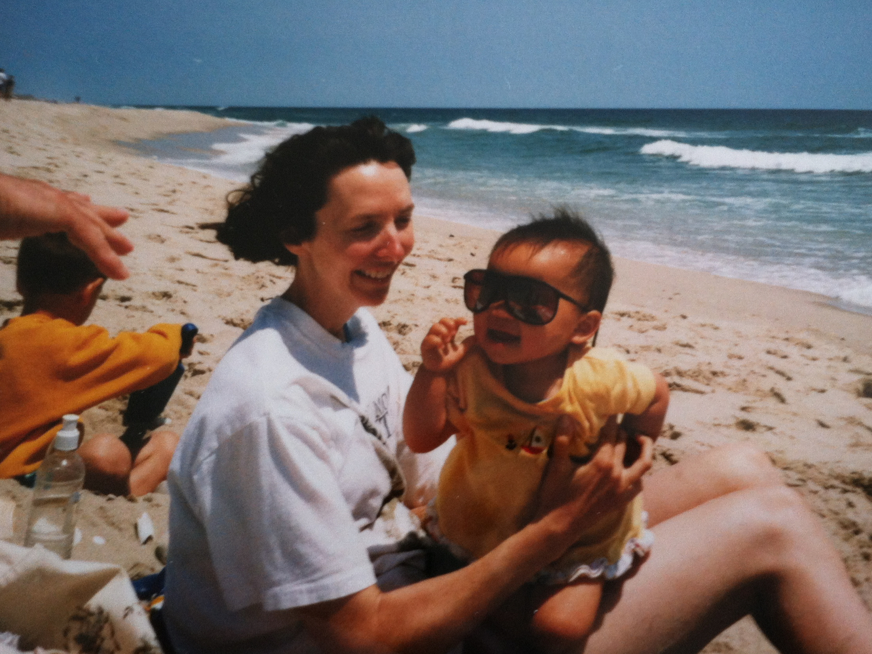caption: Emma LeMay, now 22, with her mother at the Jersey shore. LeMay, adopted from Chongqing China, was raised in Vermont and now lives in Atlanta.