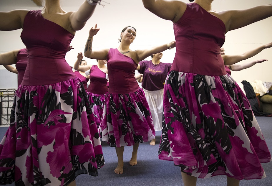 caption: Leilani Kaaiwela-Pedreira, center, practices the 'Auana dance that the group will perform at the Merrie Monarch Festival in Hilo, on Thursday, March 22, 2018, at the halau in Federal Way.