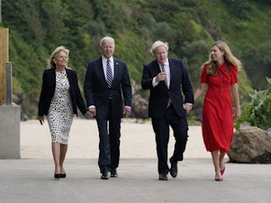 caption: President Biden and first lady Jill Biden walk with British Prime Minister Boris Johnson and his wife Carrie Johnson in  Carbis Bay, England.