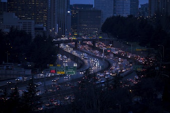 caption: Early morning traffic on I-5 is shown on Monday, January 7, 2019, from Dr. Jose Rizal Park in Seattle. 