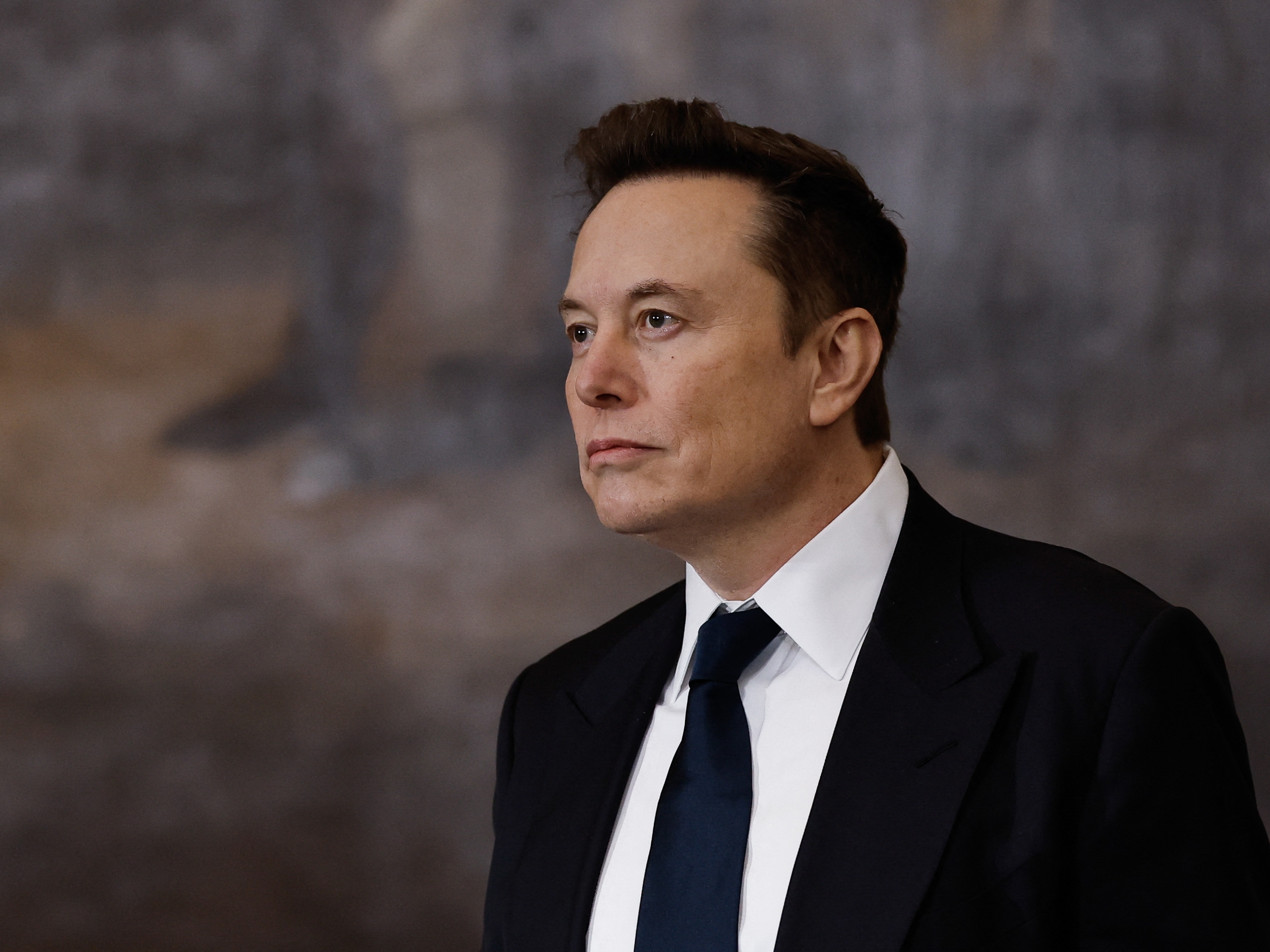 caption: Tesla and SpaceX CEO Elon Musk at President Trump's inauguration ceremony on Jan. 20. Trump has tasked Musk with leading a team focused on cutting costs in the government.