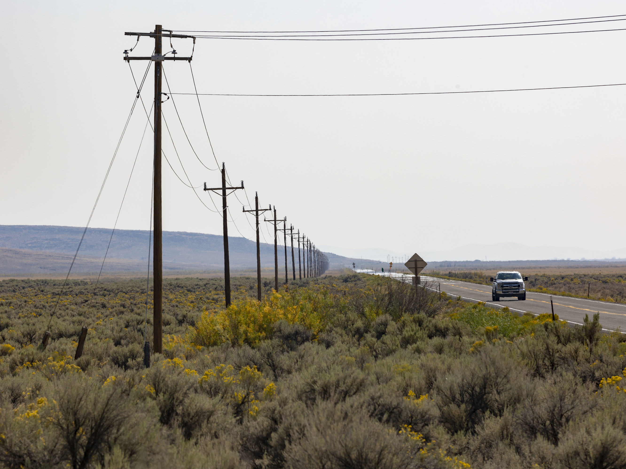 caption: The Duck Valley Indian Reservation is home to the Shoshone-Paiute Tribes and comprises about 450 square miles along the Idaho/Nevada border. Only one power line goes into it, shown here along Highway 51.