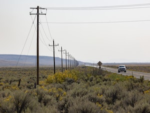 caption: The Duck Valley Indian Reservation is home to the Shoshone-Paiute Tribes and comprises about 450 square miles along the Idaho/Nevada border. Only one power line goes into it, shown here along Highway 51.
