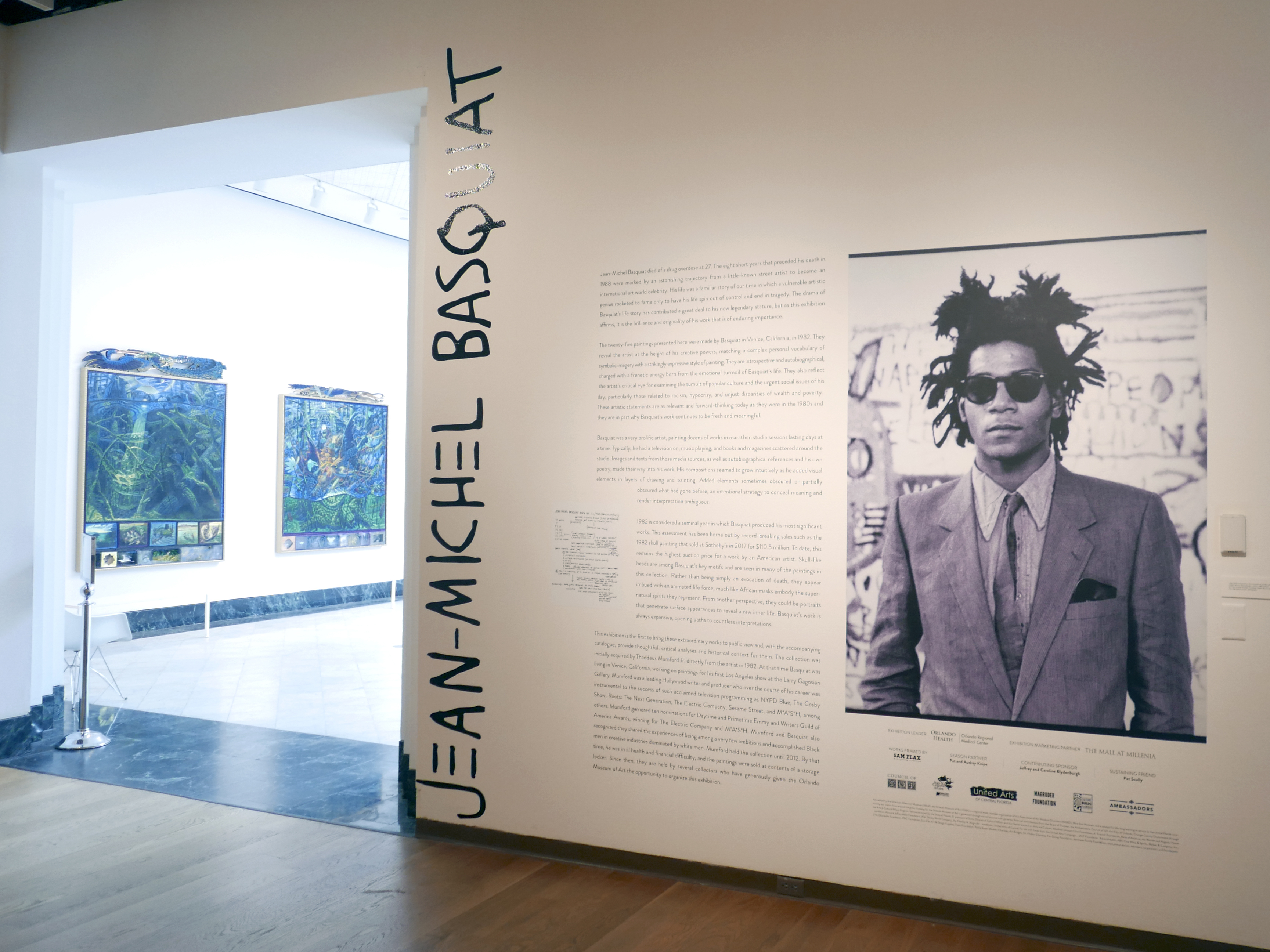 caption: The entrance to an exhibit by artist Jean-Michel Basquiat is seen at the Orlando Museum of Art on June 1, 2022, in Orlando, Fla. A former Los Angeles auctioneer has pleaded guilty in a cross-country art fraud scheme where he created fake artwork and falsely attributed the paintings to artist Jean-Michel Basquiat.