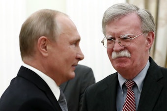 caption: National Security Adviser John Bolton speaks with Russian President Vladimir Putin at the Kremlin on Tuesday. After their meeting, Bolton told reporters the U.S. still intends to withdraw from the Cold War-era Intermediate-Range Nuclear Forces Treaty.