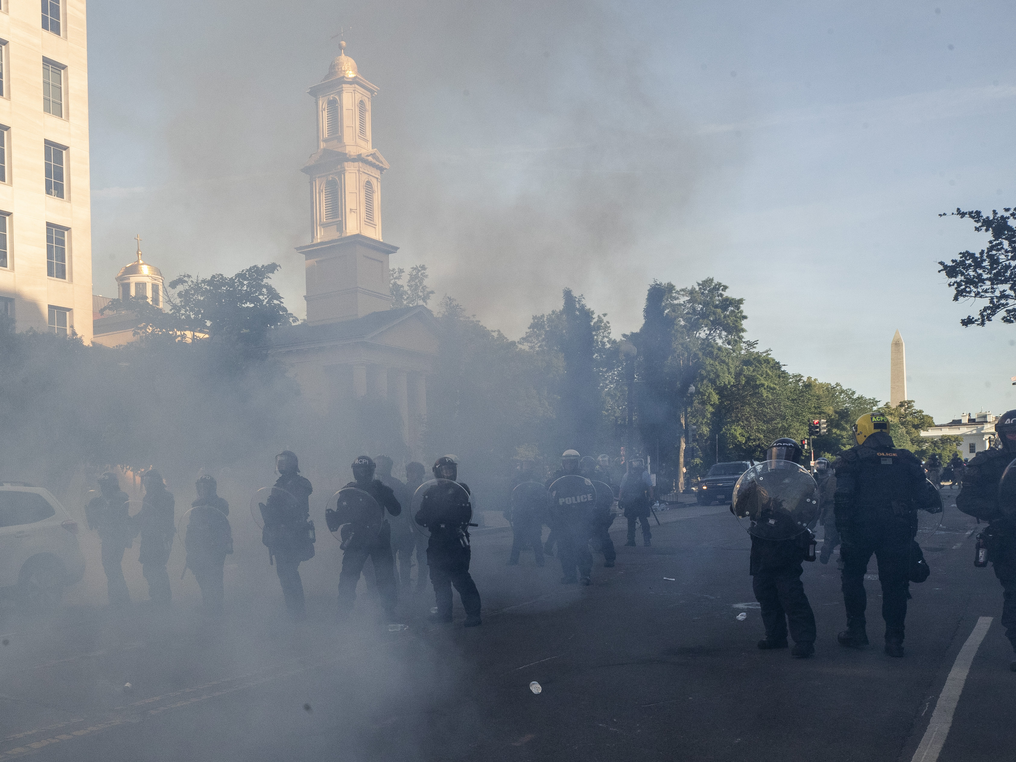caption: On Monday, police move demonstrators away from  Lafayette Park, across from the White House.