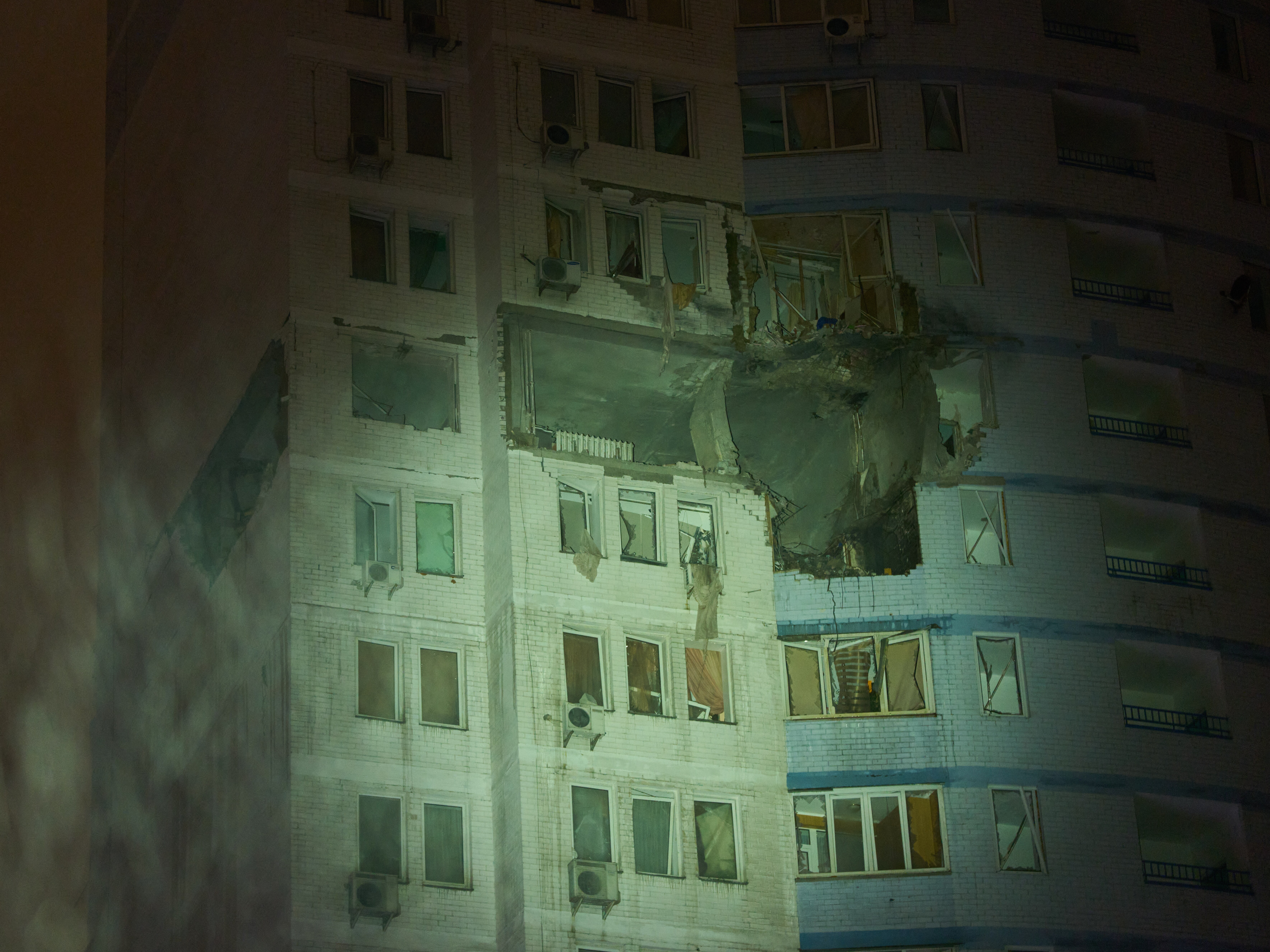 caption: A residential building is damaged after a Russian air strike during a heavy snow storm in Kyiv, Ukraine, early Friday, Jan. 9, 2026.