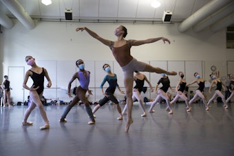 caption: Cecilia Iliesiu, center, rehearses with other dancers for the Pacific Northwest Ballet's Nutcracker performance on Friday, November 19, 2021, at McCaw Hall in Seattle. 