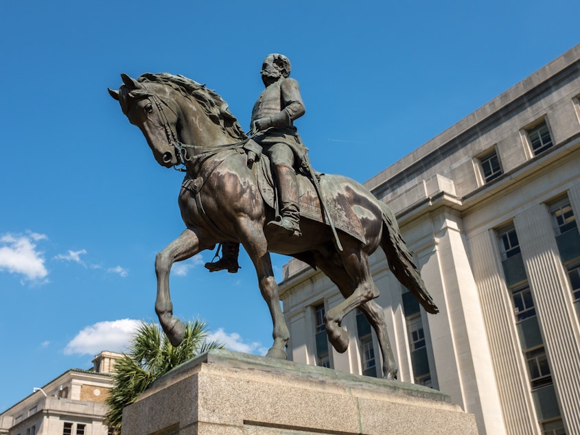 caption: A statue of Confederate general and slave owner Wade Hampton III on horseback in the grounds of South Carolina State House.