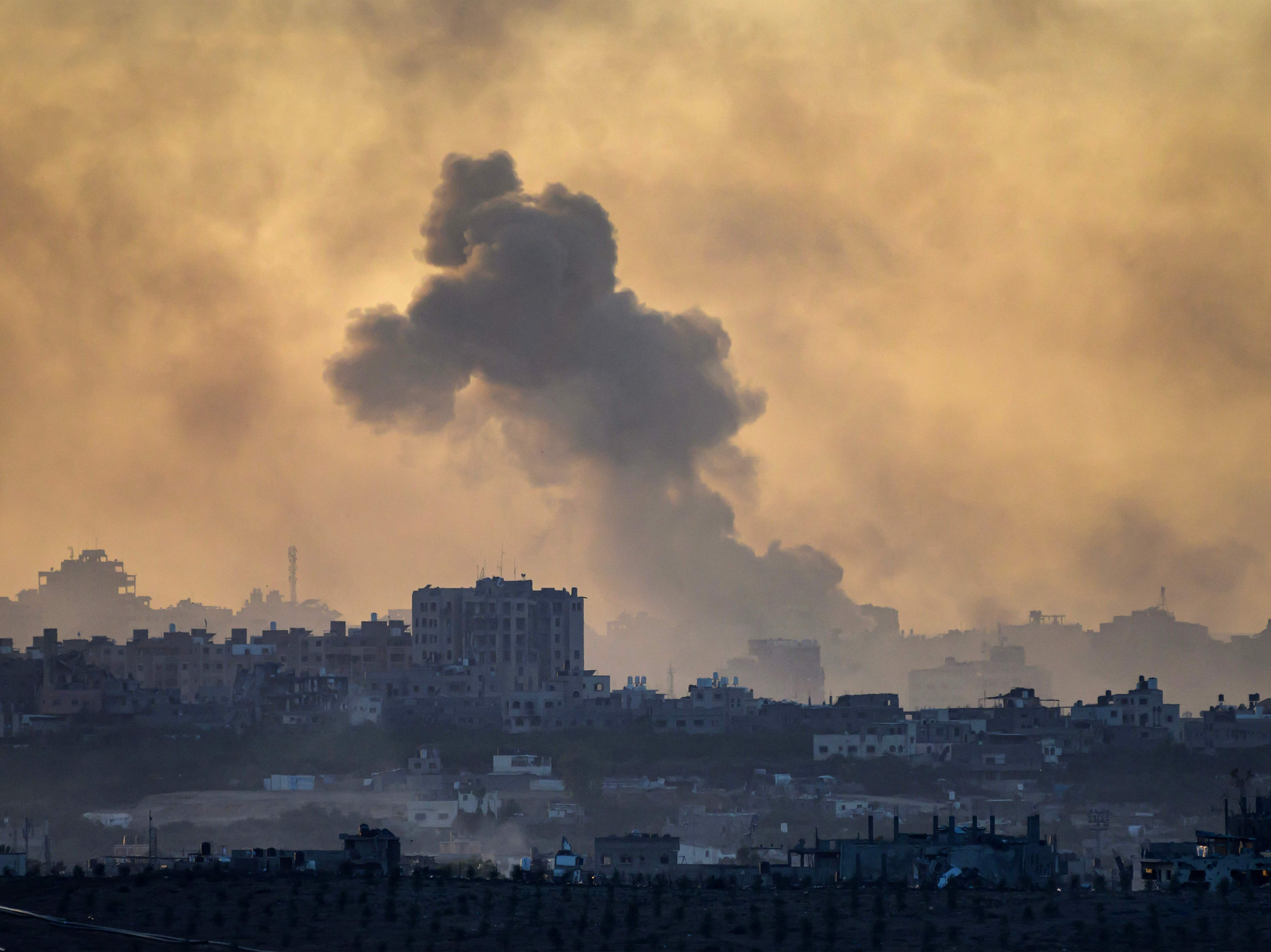 caption: This picture taken from a position in southern Israel near the border with the Gaza Strip shows smoke billowing in the the Palestinian territory after an Israeli strike on November 21, 2023, amid ongoing battles between Israel and the Palestinian Hamas movement.