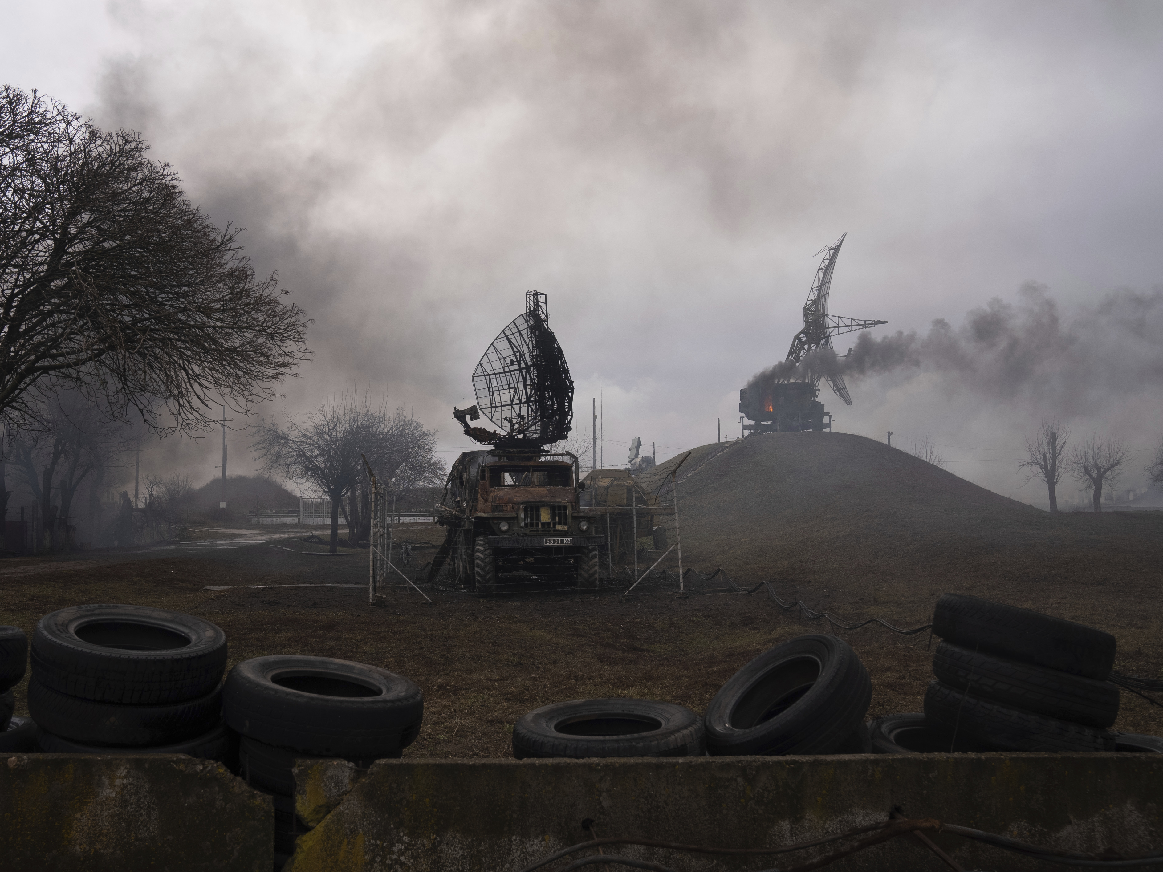caption: Smoke rises from an air defense base in the aftermath of an apparent Russian strike in Mariupol, Ukraine, on Thursday.