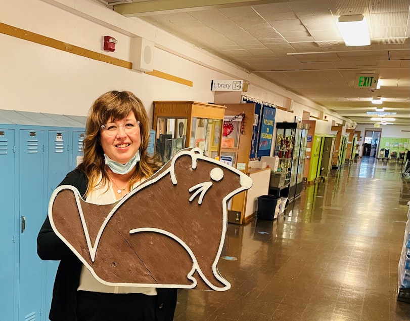 caption: Wedgwood Elementary School Principal Christy Smith holds the Wedgwood Elementary marmot symbol.