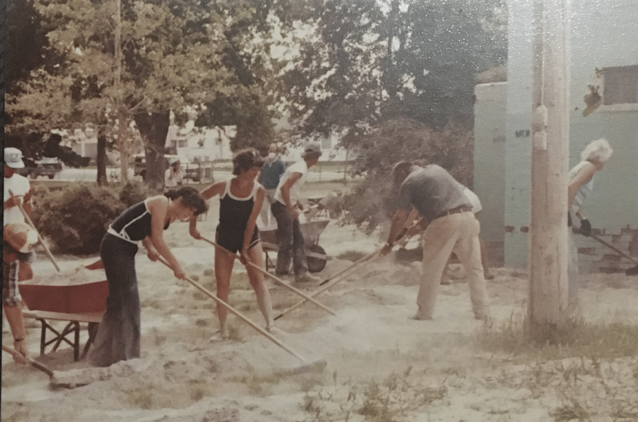 caption: Residents of Ritzville, Washington, clean up ash in the city park after Mount St. Helens erupted on May 18, 1980.