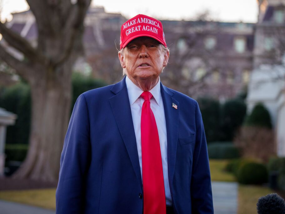 caption: President  Trump takes a question from a reporter before boarding Marine One on the South Lawn of the White House on Friday.