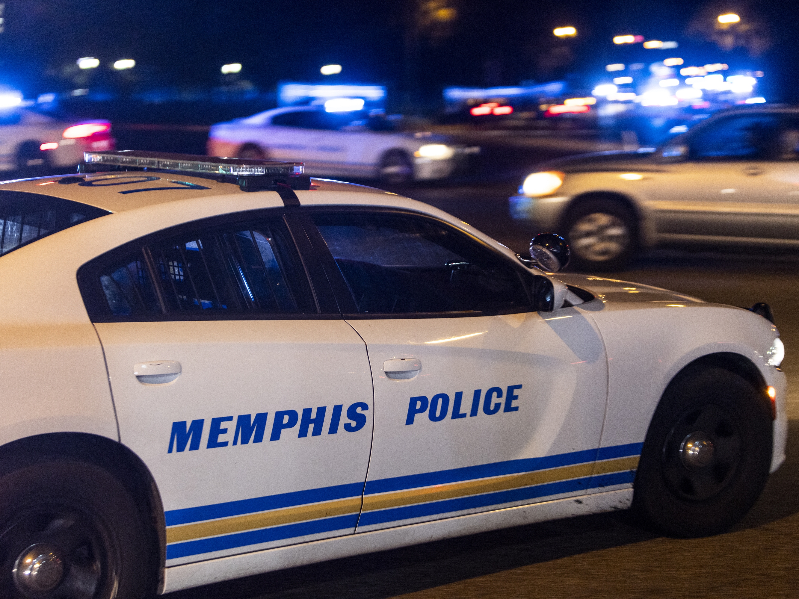 caption: In this file photo from Sept. 2023, a police car in Memphis is shown on the scene of a reported carjacking. On Sept. 12, President Trump announced in an interview on "Fox &amp; Friends" Memphis will be the next site of federal action to combat crime, following intervention in the nation's capital, Washington, D.C.