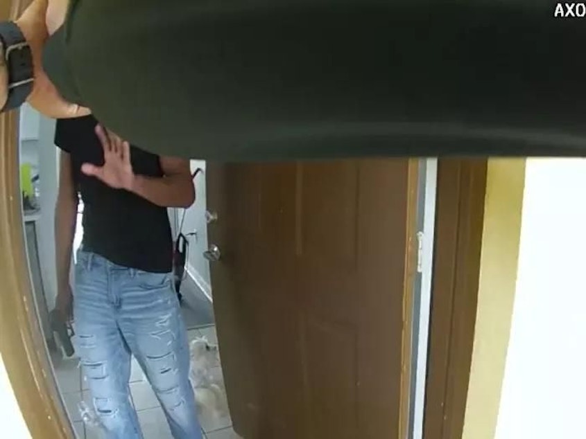 caption: U.S. Airman Roger Fortson answers the door of his apartment on May 3, 2024, as captured by the body camera of the Okaloosa County sheriff's deputy responding to a report of a domestic disturbance. A split second later, the deputy fired at Fortson, killing him.