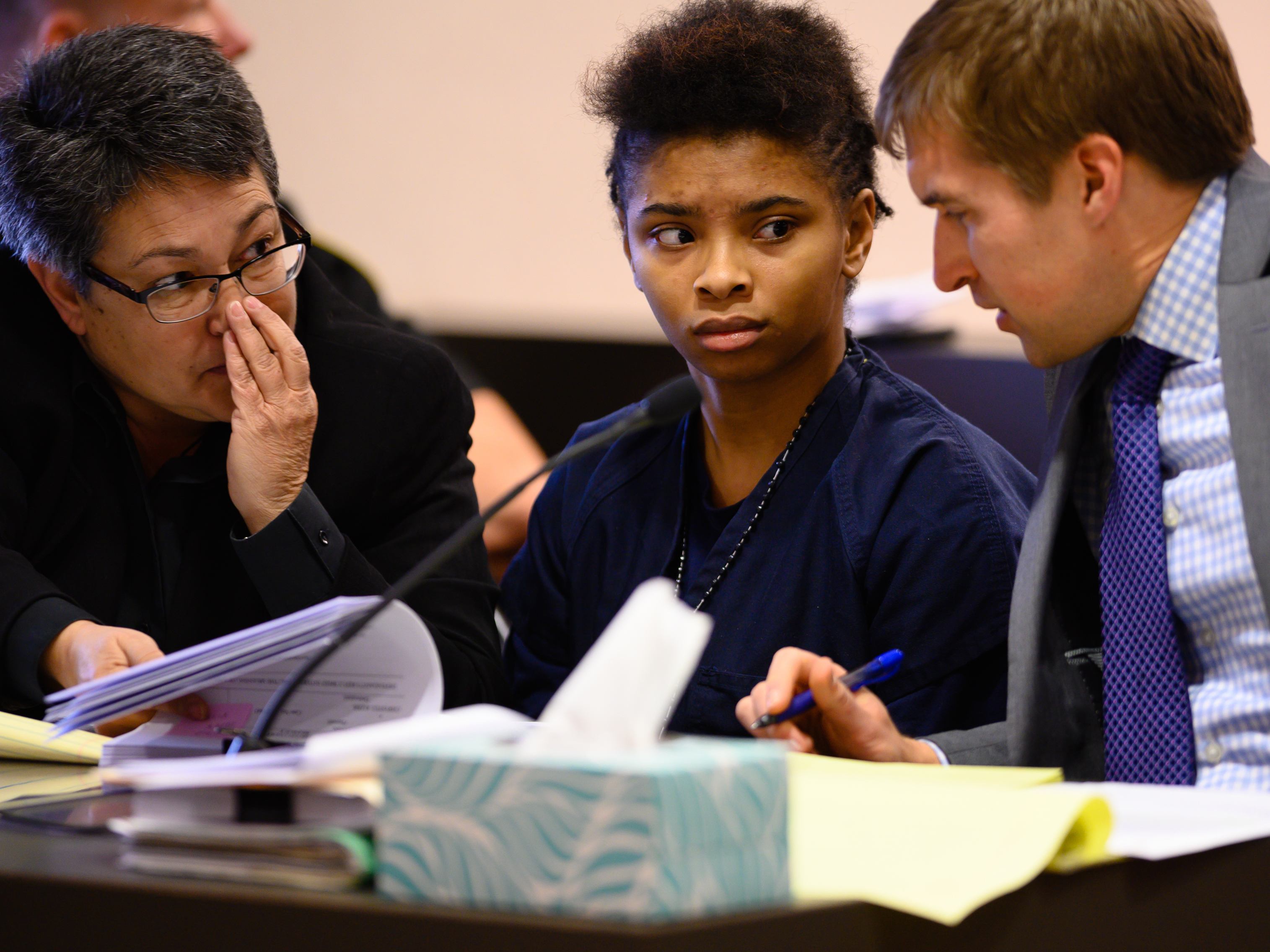 caption: Chrystul Kizer (shown here with her lawyers in 2019) is arguing that it was self-defense when she killed the man who sexually abused her.