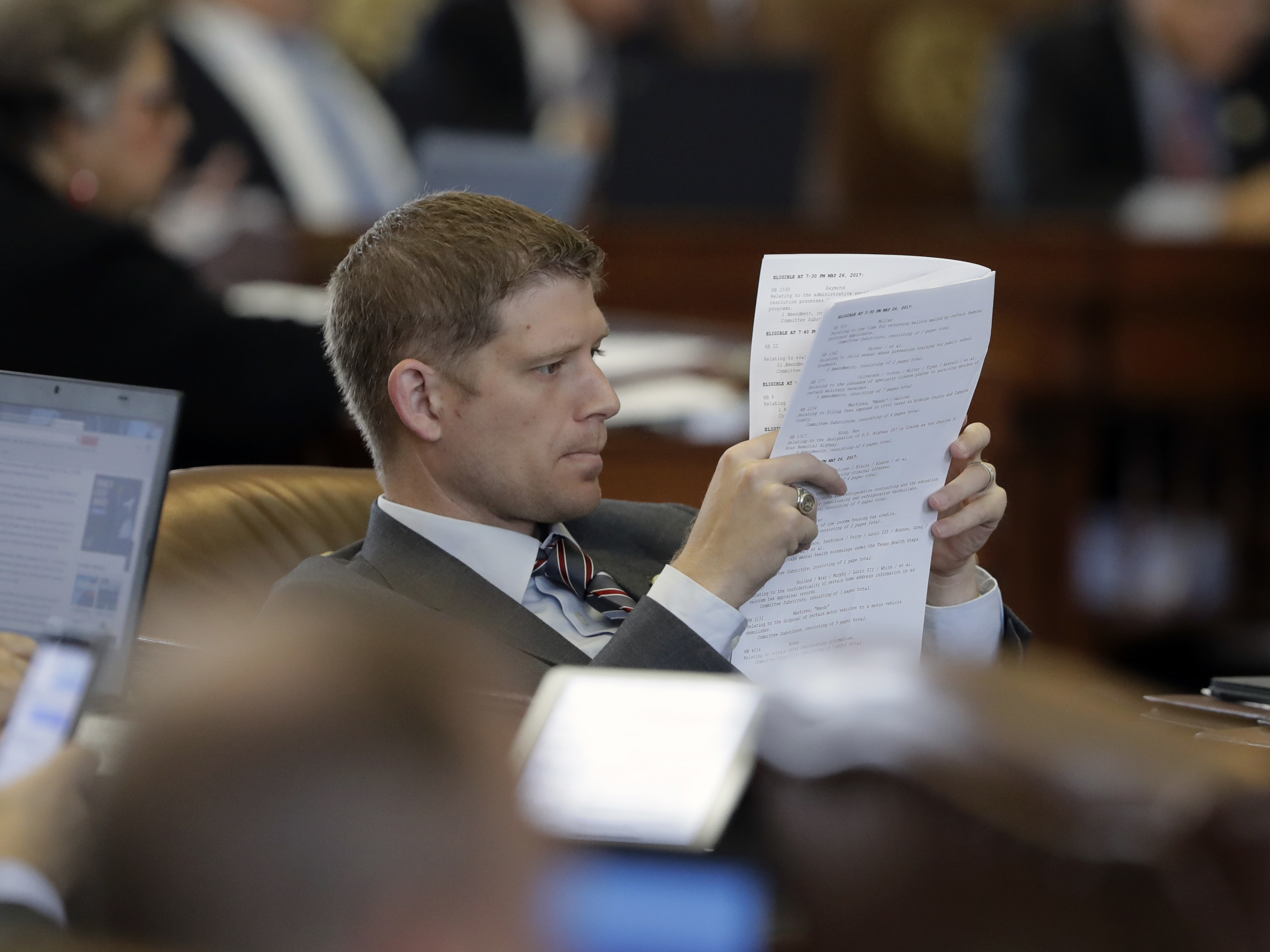 caption: Texas Rep. Matt Krause, R-Fort Worth, looks over the calendar as law makers rush to finish business, Friday, May 26, 2017, in Austin, Texas.