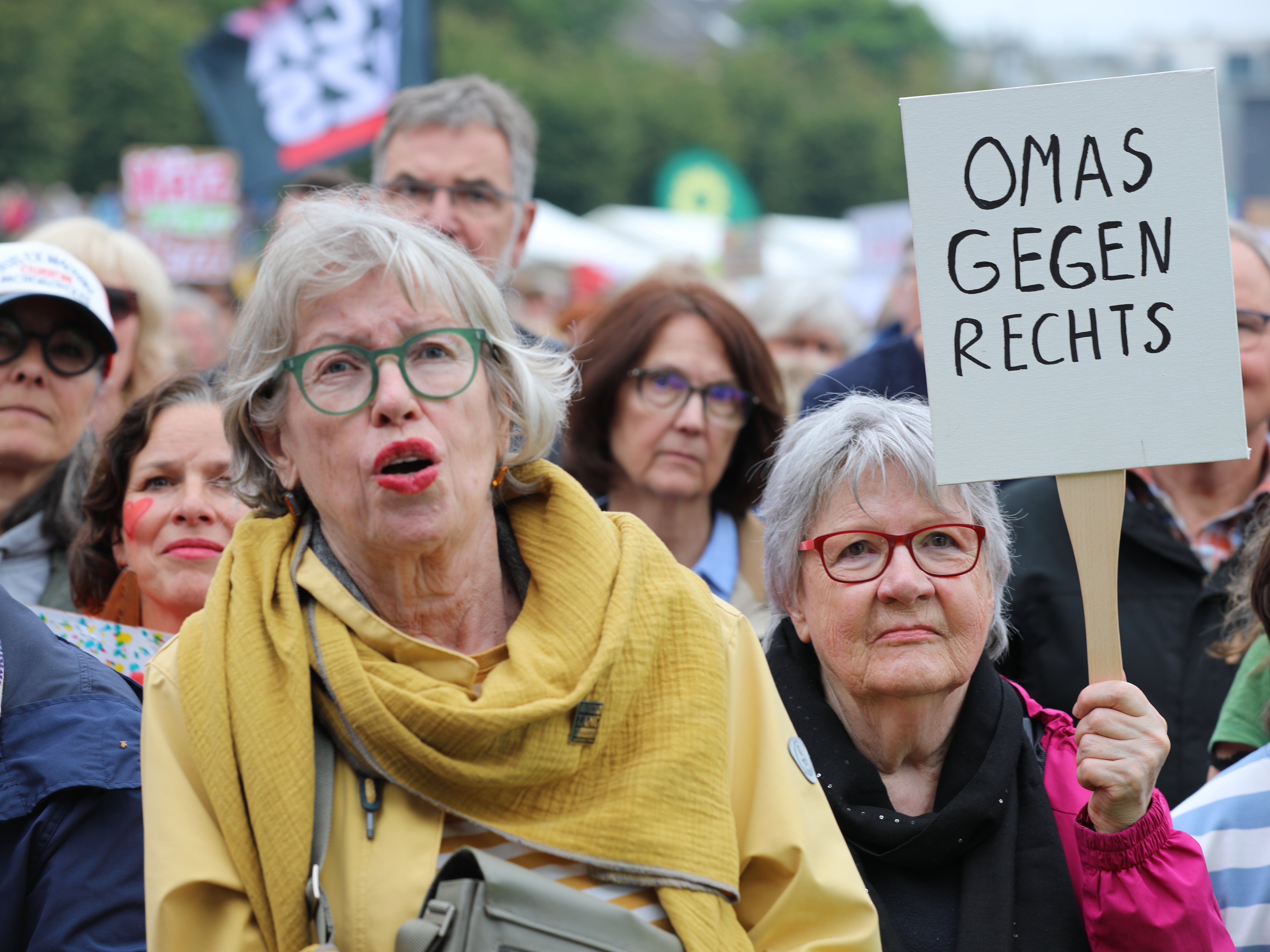 caption: Demonstrators with signs reading "Grandmas against the far-right" protest against right-wing extremism and racism at the Deutzer Werft shipyard in Cologne, Germany, June 1.