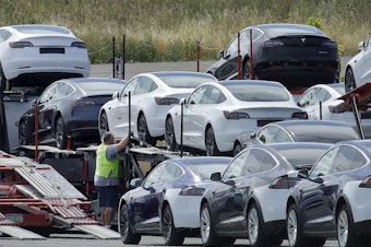 caption: Tesla cars are loaded onto carriers at the automaker's plant in Fremont, Calif., on May 13, 2020. The company is recalling nearly 363,000 vehicles with its "Full Self-Driving" system.