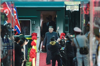caption: Kim Jong Un steps off his train in 2019 ahead of the U.S.-North Korea summit.