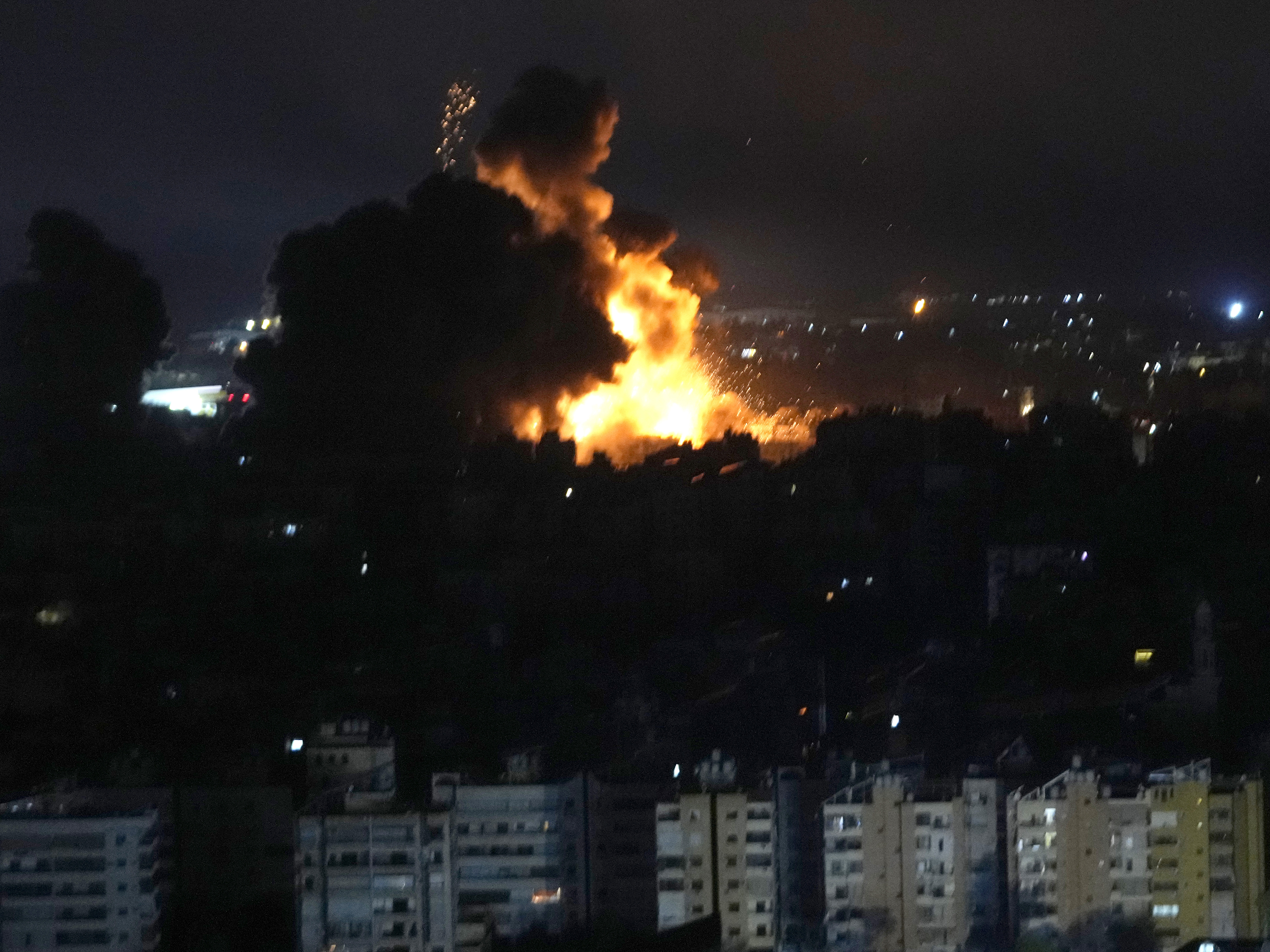 caption: Flames rise from Israeli airstrikes in Dahiyeh, Beirut, Lebanon, Friday.